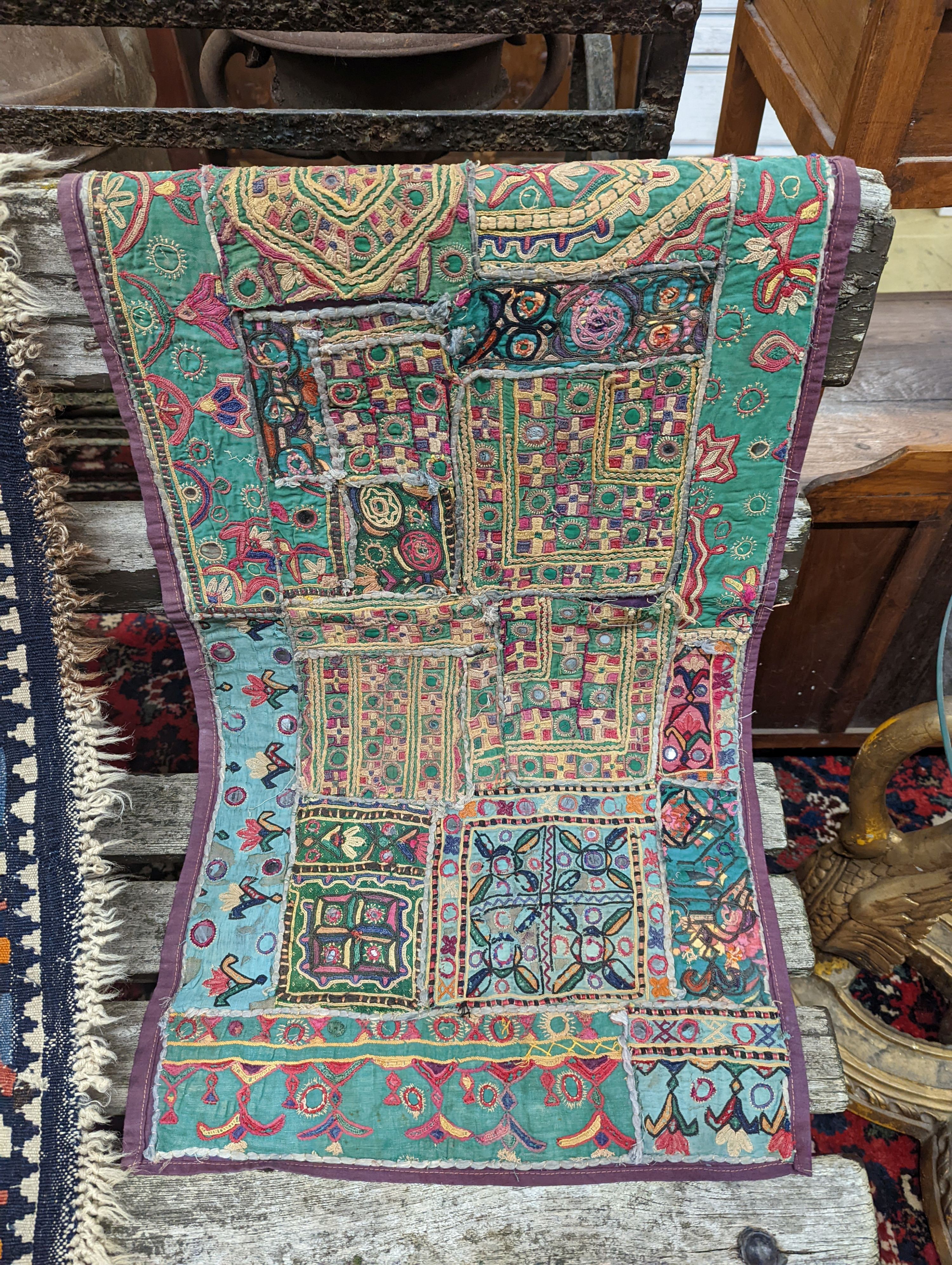 A Kelim flatweave rug, an Indian fabric panel and a saddle bag